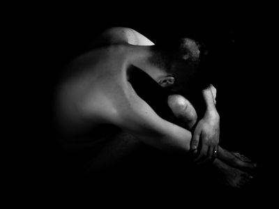 Grayscale Photography of Naked Person Sitting On The Floor With His Head Bent To His Knees In A Dark Place